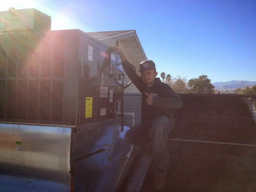 HVAC technician performing HVAC Inspection on a rooftop unit in Allentown